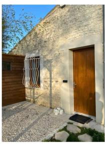 a house with a wooden door and a window at Appartement calme in Sigogne +7 photos