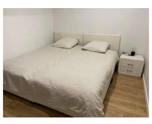 a bed with two pillows on it in a bedroom at Appartement calme in Sigogne