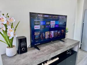 a flat screen tv sitting on top of a counter at Apartment Paris La Défense Eiffel Tower Skyline in Puteaux +6 photos
