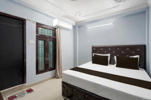 a bedroom with a large bed and a window at Hotel O STAR GALAXY in Bhauli