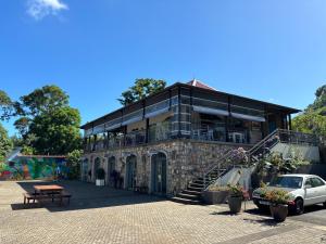 a building with a car parked in front of it at Villa lagoon view Baie du cap bel ombre in Baie du Cap