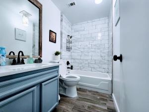 a bathroom with a sink and a toilet and a tub at Spacious Family Home in Round Rock w Private Yard in Round Rock +30 photos