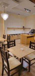 a dining room with tables and chairs in a room at B Boutique Hotel in Tirana