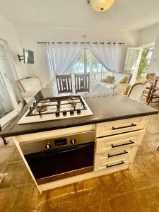 a kitchen with a stove top on a counter at Beachfront Apartment in Tergniet