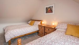 two twin beds in a room with two candles at Woodview Studio - Westport in Westport