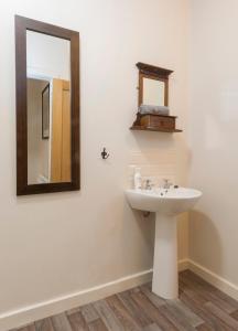 a bathroom with a sink and a mirror at Woodview Studio - Westport in Westport +11 photos