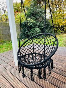 a swing on a deck with a porch at OVERNIGHT No5 - Bungalow, Billard, Dart, Kamin in Hannover