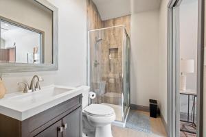 a bathroom with a shower and a toilet and a sink at Spacious 4BR w Fenced Yard in Round Rock +20 photos