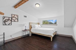 a white bedroom with a bed and a window at Spacious 4BR w Fenced Yard in Round Rock