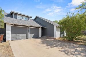 a house with a garage and a tree at Spacious 4BR w Fenced Yard in Round Rock