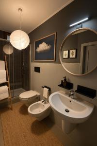 a bathroom with a sink and a toilet and a mirror at Cognaia Loft in Arezzo