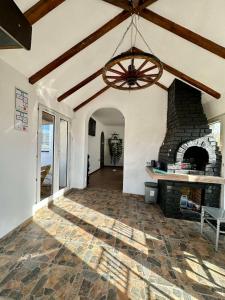a living room with a stone fireplace and a chandelier at Brick House in Kragujevac