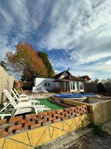 a group of lounge chairs and a swimming pool at Brick House in Kragujevac