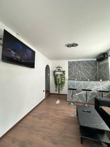 a living room with a flat screen tv on a wall at Brick House in Kragujevac
