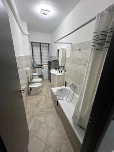 a bathroom with two toilets and a bath tub at Relax suite in Alessandria