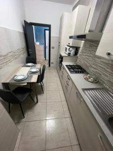 a kitchen with a table and a dining room at Relax suite in Alessandria