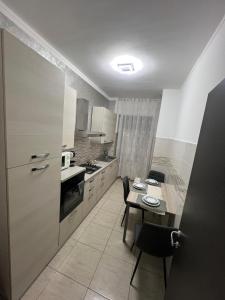 a kitchen with a table and a small table and chairs at Relax suite in Alessandria