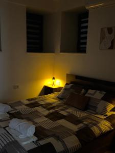 a bedroom with a bed with a lamp on it at Hypogeon Residence in Bitola
