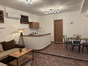 a living room with a couch and a table at Hypogeon Residence in Bitola