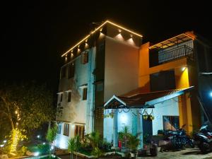 a building with lights on it at night at The Inchara Vista in Chikmagalūr