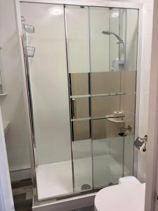 een glazen douche in een badkamer met toilet bij Three Wheat Heads in Thropton