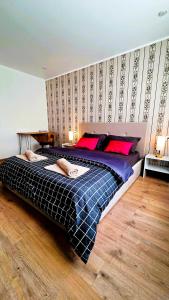 a large bed in a bedroom with a wall at Морской бриз in Aktau