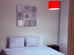 a bedroom with a bed and a picture on the wall at Apartment Paris La Défense Eiffel Tower Skyline in Puteaux