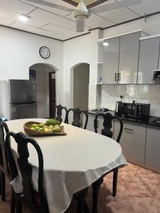 a kitchen with a table with a bowl of fruit on it at Dona's Villa, Coastal Tropical House in Kepungoda