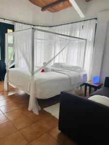 a bedroom with a white bed with a canopy at Luxury Penthouse suite in Altos del Maria in Sorá +67 photos