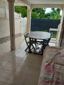 a table and chairs on a porch with a table at lorispring in Îlet à Christophe