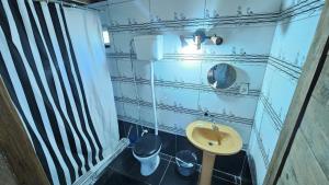 a bathroom with a sink and a mirror at Kosmik House in Punta Del Diablo