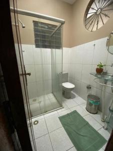 a bathroom with a toilet and a glass shower at House for rent in Residencial Santo Antônio in Belém