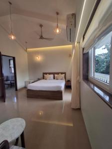 a bedroom with a bed and a large window at Villa with Pool Near Mandrem Beach in Mandrem +75 photos