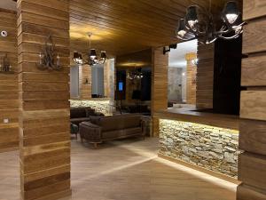 a living room with a stone wall at Bambi in Pamporovo +120 photos