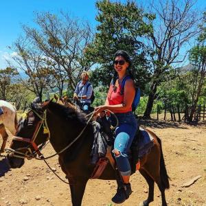 two people riding on a horse in a field at Roots Casa Rústica in Valle Hornito +160 photos