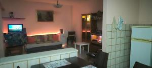 a living room with a couch and a tv in a room at Kounis Villa in Chalkida