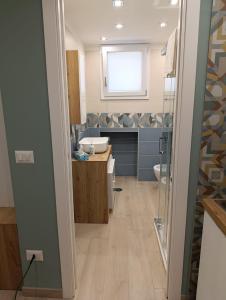 a bathroom with a sink and a toilet at AparthouseRisorgimento BORBONE in Frattamaggiore +7 photos