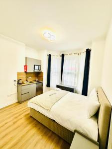 ノッティンガムにあるAvon Stone Apartmentsの大きなベッドとキッチンのある寝室