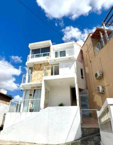 a large white house with a blue sky at Suíte Lunar Prime in Serra de São Bento