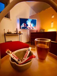 a table with a bowl of food and a glass of soda at Joe's Home Naumburg -modern,vintage Apartment in Naumburg
