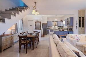 a living room with a couch and a table and a kitchen at Villa Meliti Paros in Angairiá