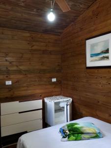 a small room with a bed and a refrigerator at Pousada João e Maria in Trindade +69 photos
