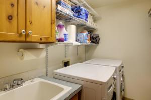 a small kitchen with a sink and a washing machine at Rustic Gotham Bay Cabin on Lake Coeur dAlene in Harrison +22 photos
