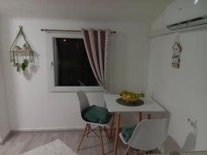 a small kitchen with a table and a window at Apartman Mali kutak in Gradačac