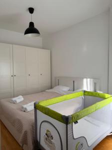 a bedroom with a bed with a green and white crib at Apartman Petrovic in Vranje