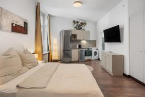 een slaapkamer met een groot bed en een keuken bij Loftly 5min zu Fuß Charite - 45m2 - Self Check-In - 300mbit in Berlijn