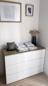 a shelf with two towels and a vase on it at HOUSE RODRIGUEZ in San Lazzaro di Savena