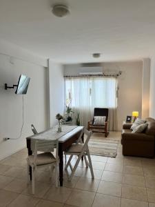 a living room with a table and a couch at Edificio Resistencia in Resistencia