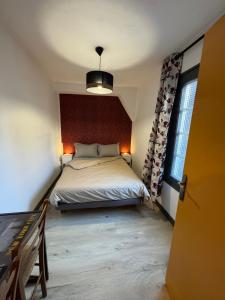 a bedroom with a bed and a large window at L'Appart du Coq - Proche du Zoo de Beauval & des châteaux in Selles-sur-Cher