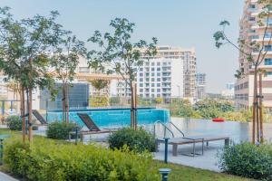 a swimming pool with two benches and a table at Casa Haven Retreat in Dubai